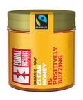 A jar of Organic Raw Clear Honey that says "is positively buzzing"