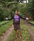 PRODECOOP coffee farmer between rows of her coffee trees